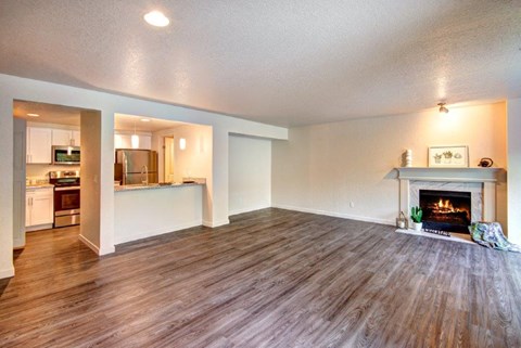 a living room with a fireplace and a wooden floor