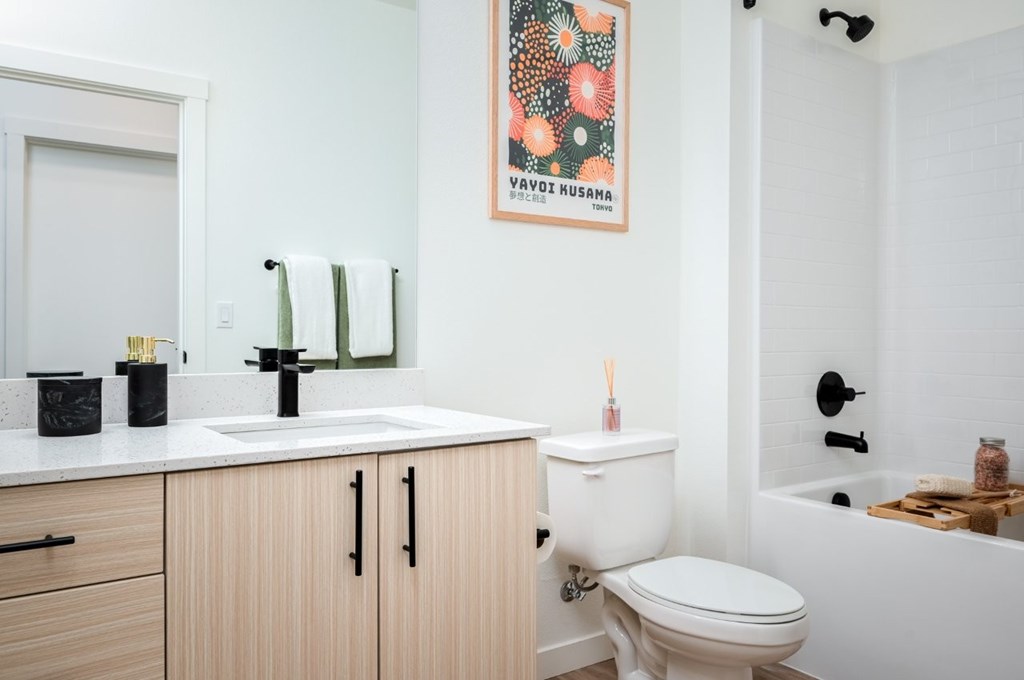 The Wes Gresham Oregon Apartments A bathroom with a white toilet, a sink, and a bathtub.