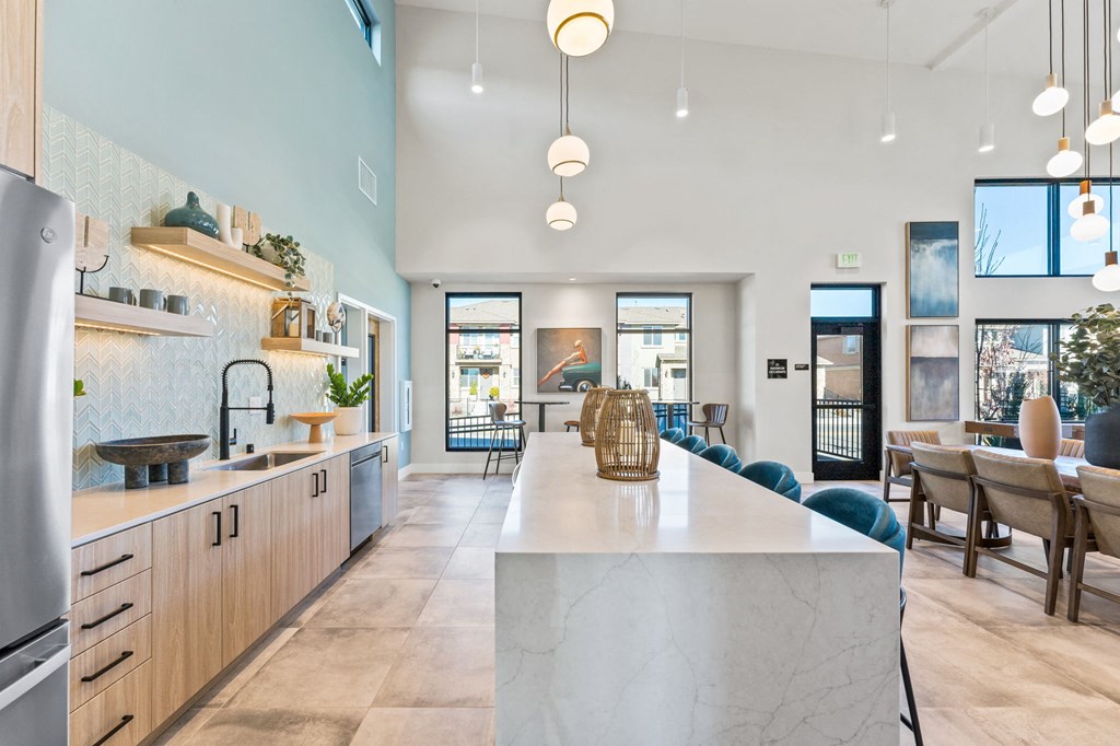 a large kitchen with a marble counter top and a dining room