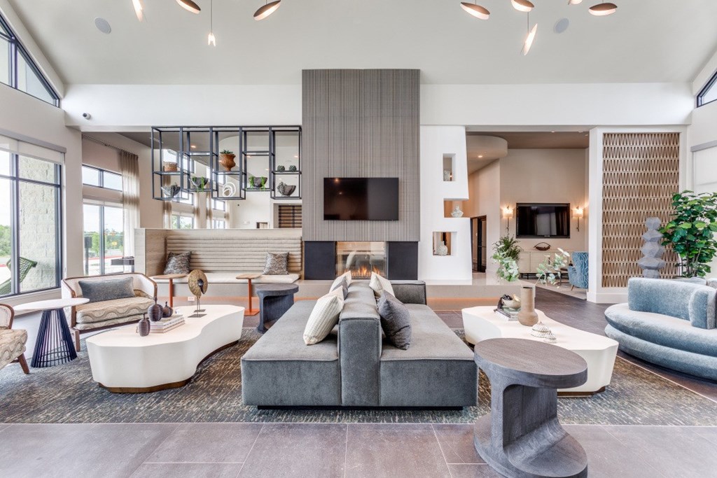 A modern living room with a grey sofa and a wooden coffee table.