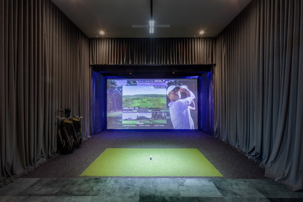 A screen in a room with a man playing golf.