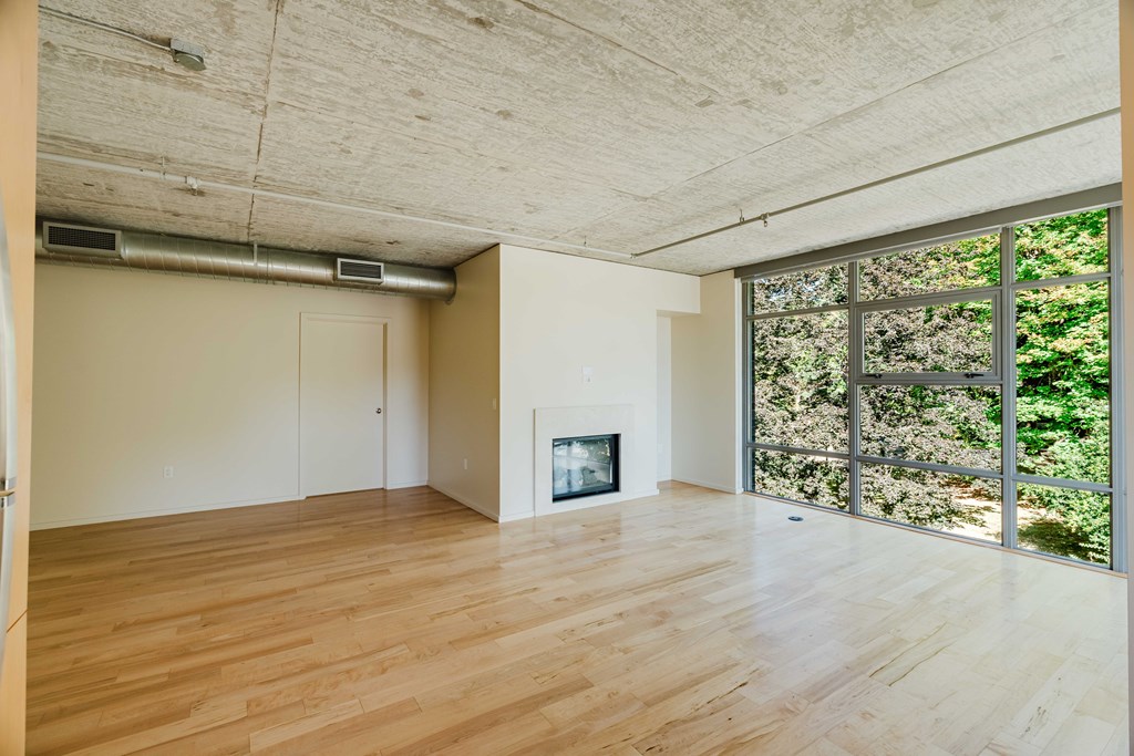 A room with wooden floors and a fireplace.