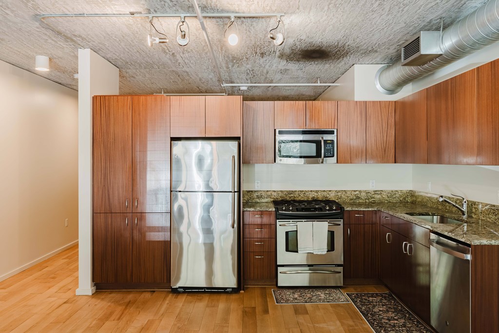 A kitchen with wooden cabinets and stainless steel appliances.