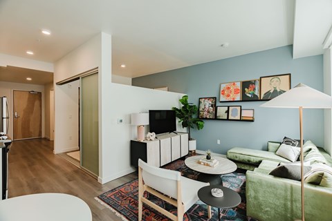 A living room with a white couch and a coffee table.