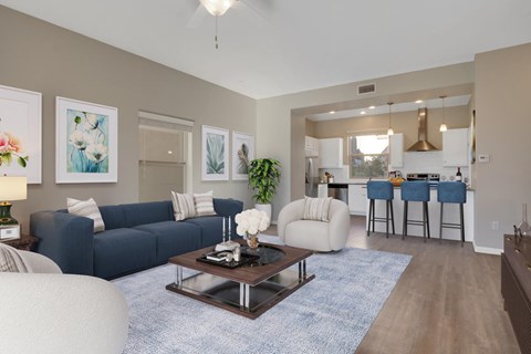 A living room with a blue couch and a coffee table.