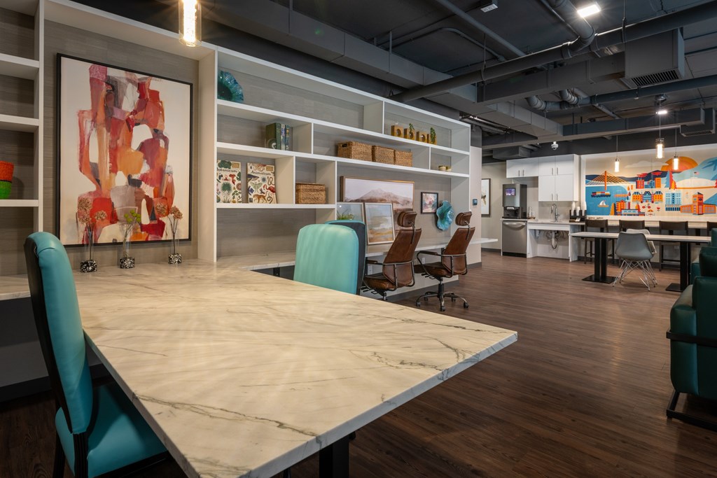 A conference room with a long table and chairs.