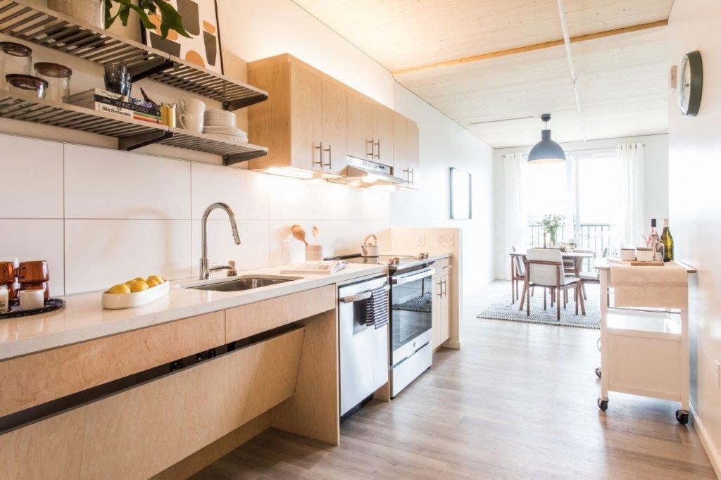 a kitchen with a sink and a stove and a table