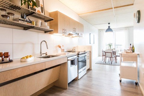 a kitchen with a sink and a stove and a table