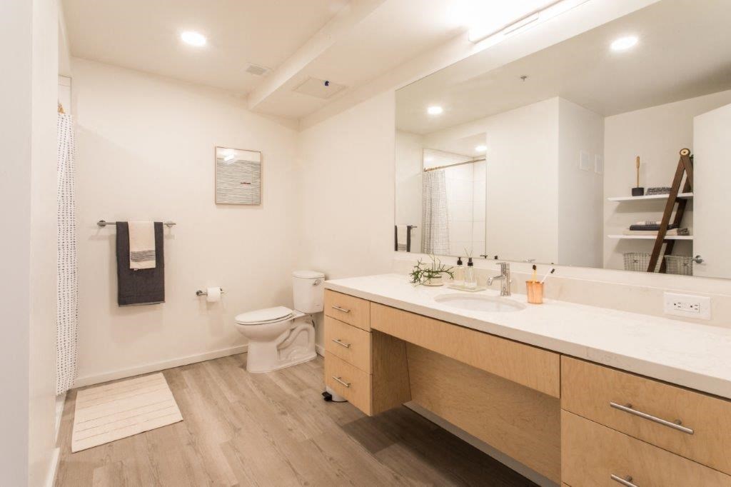 a bathroom with a sink and a toilet and a mirror