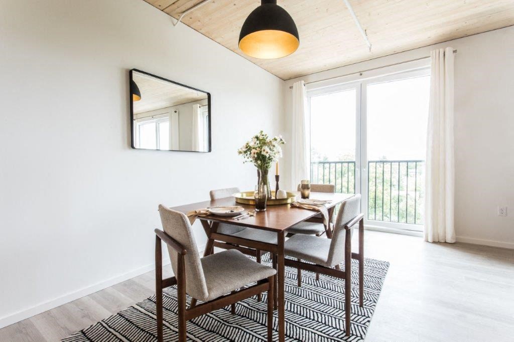 a dining room with a wooden table and chairs