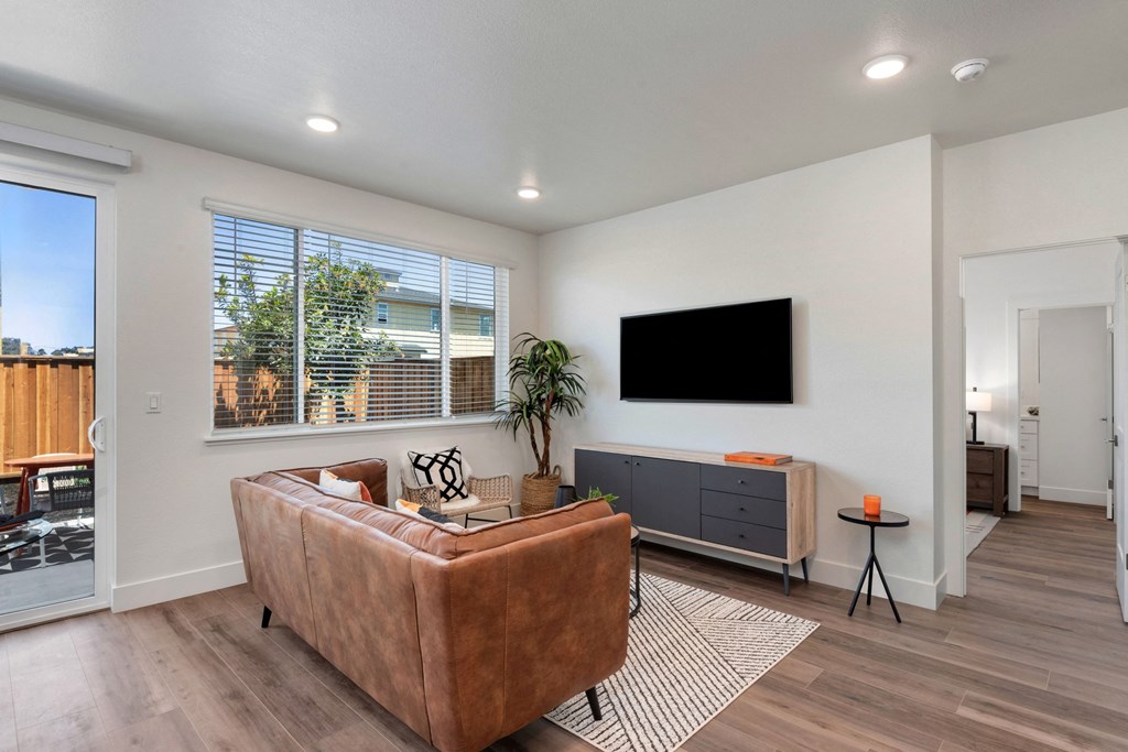 an open living room with a couch and a tv