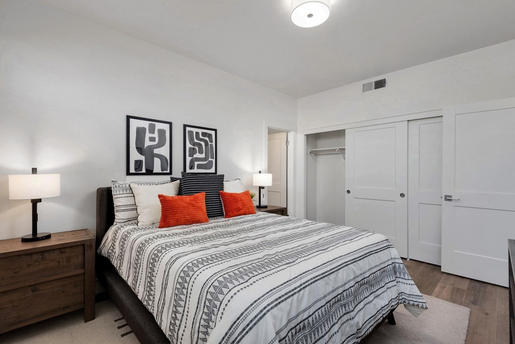 a bedroom with a large bed and white closets