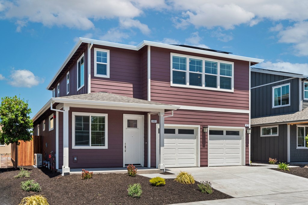 a red house with a garage and a driveway