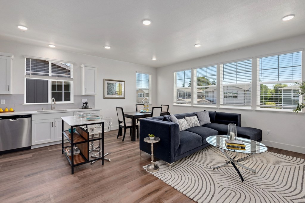 an open living room and kitchen with a couch and a table