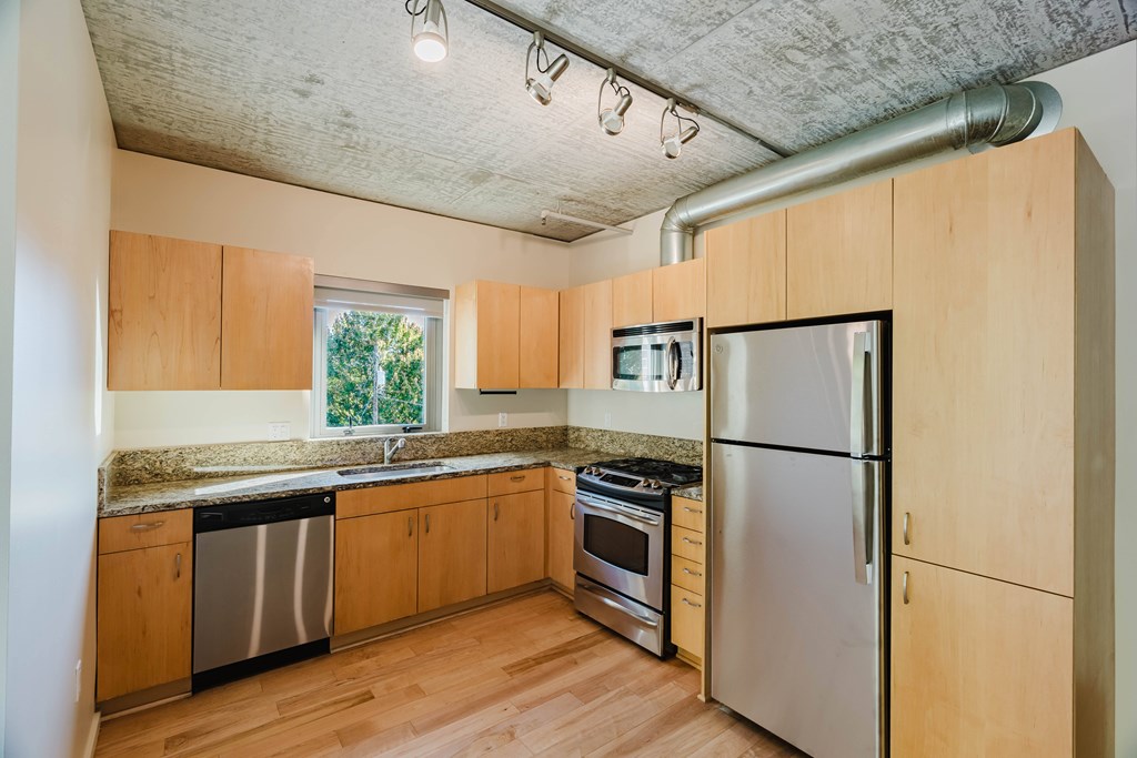 A kitchen with wooden cabinets and stainless steel appliances.