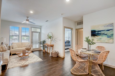 A living room with a dining table and chairs.