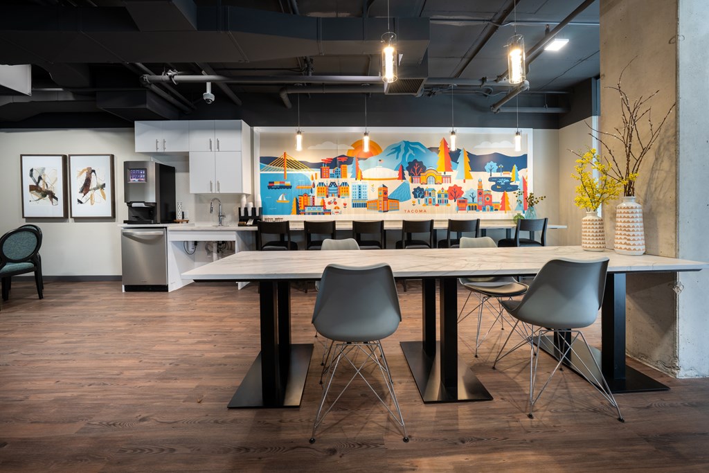 A modern meeting room with a long table and chairs.
