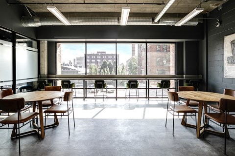 A conference room with a long table and chairs.