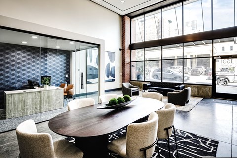 A modern dining room with a large table and chairs.