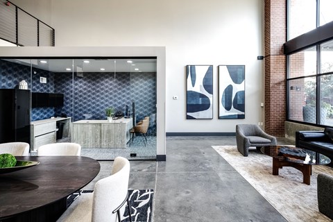 A modern living room with a dining table and chairs.