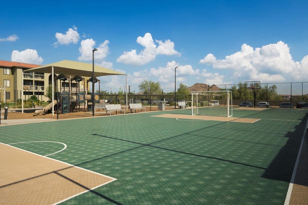 a tennis court with a building in the background