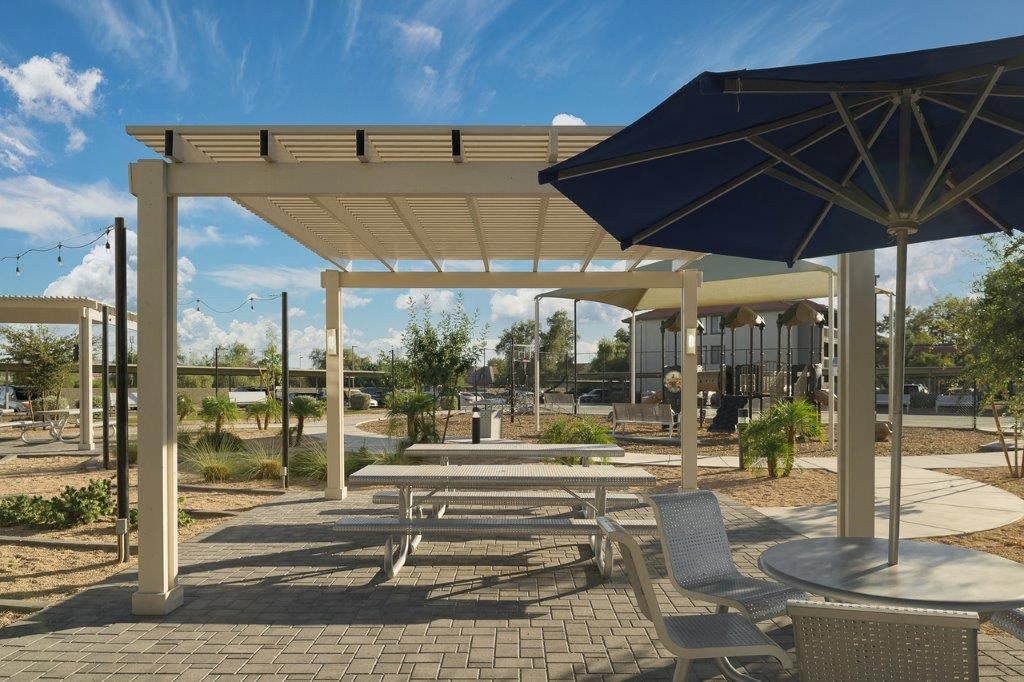 a picnic area with tables and umbrellas