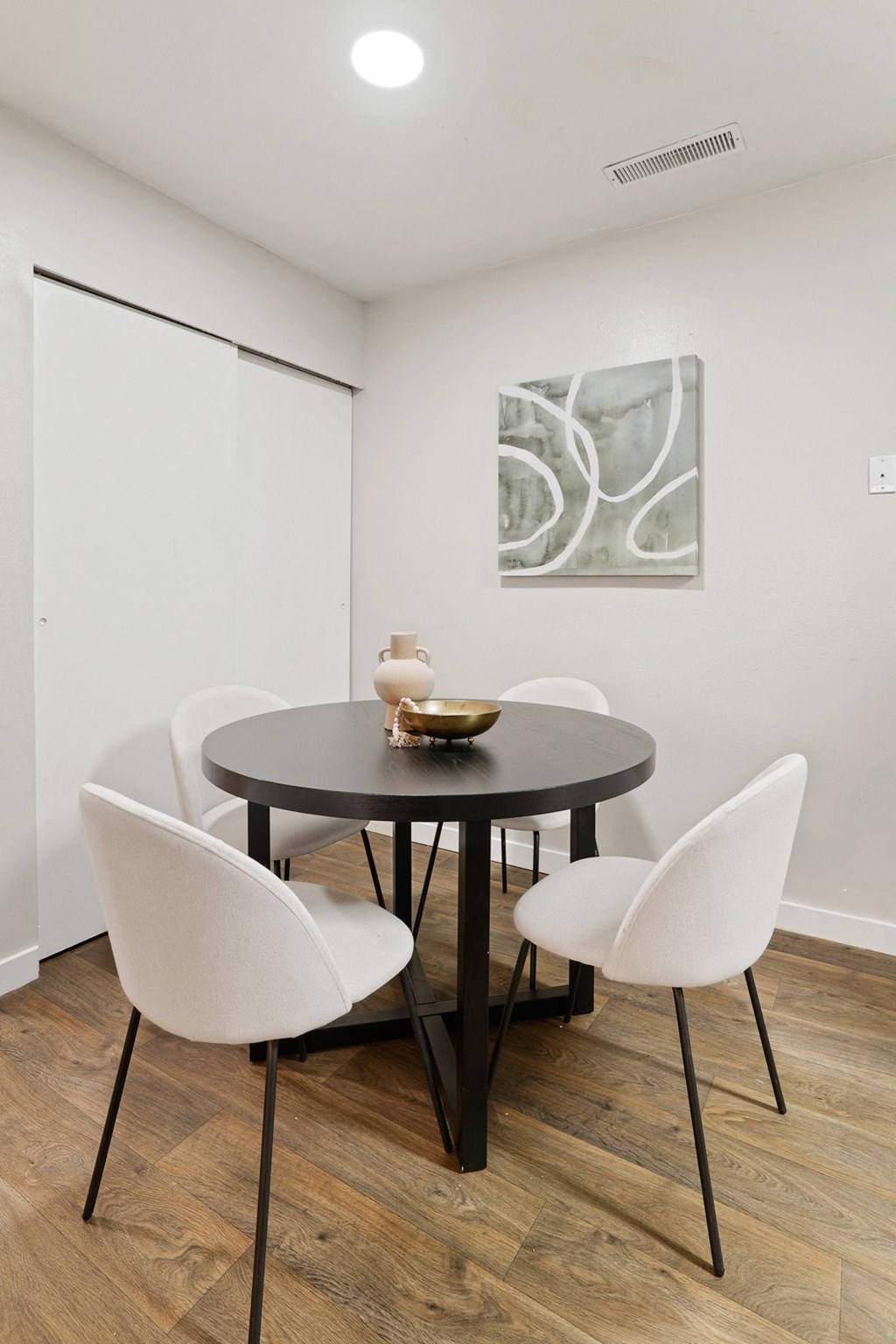 The Grove Apartments Dining Area 4 white chairs and round table