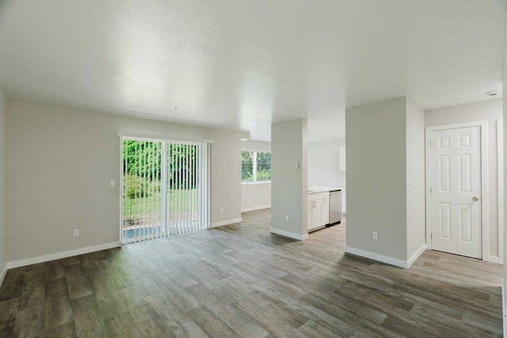 A room with wooden floors and white walls.