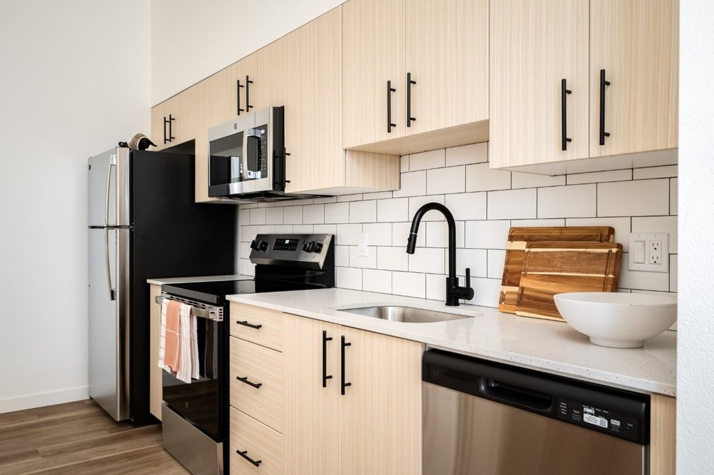 The Wes Gresham Oregon Apartments kitchen counter with bright wood cabinets and stainless steel applicances