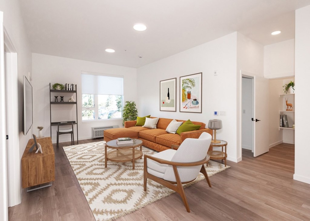 Arts Plaza Gresham Oregon Apartments A living room with a couch, a chair, and a rug.