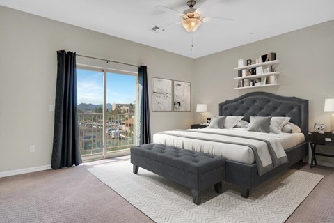 A bedroom with a large bed and a view of the city.