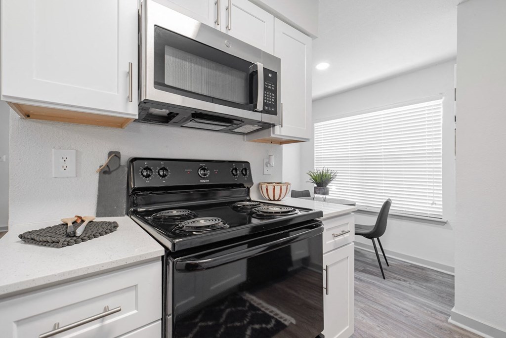 a kitchen with a stove and a microwave