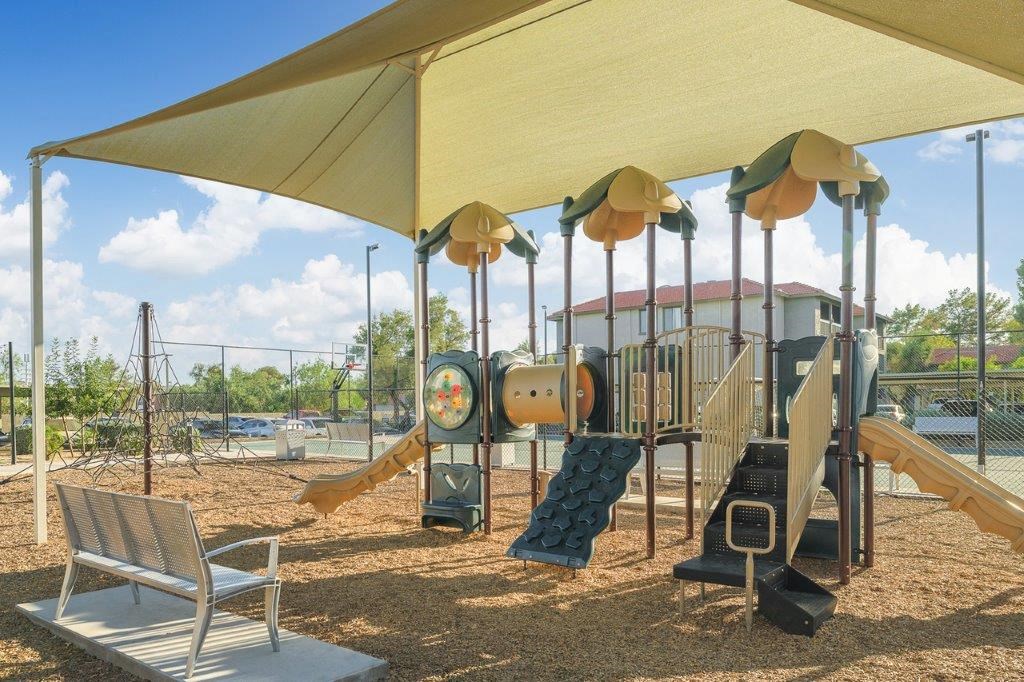 a playground with a swing set and other playground equipment
