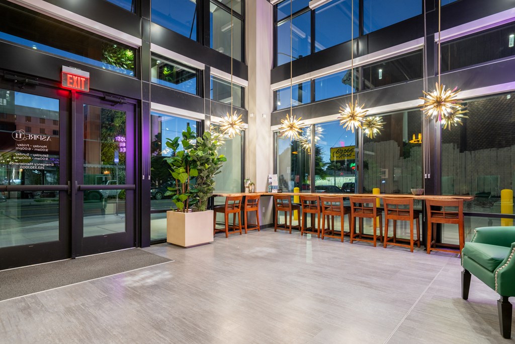 A large glass door with a red exit sign above it.
