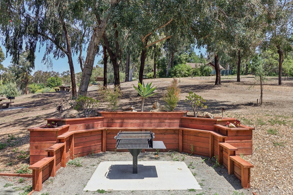 A park bench sits in the middle of a circular wooden structure.