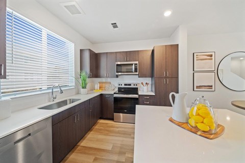 A modern kitchen with wooden cabinets and stainless steel appliances.