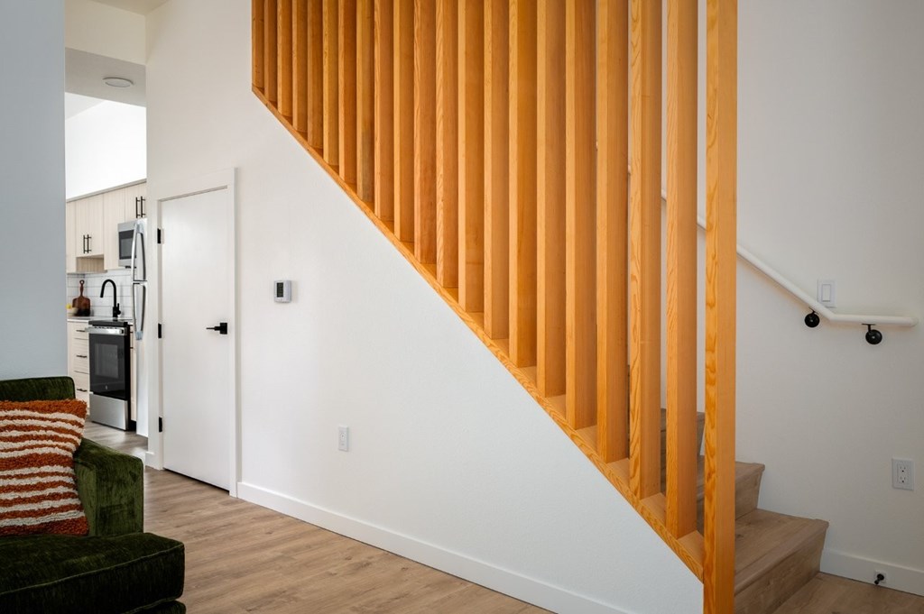 The Wes Gresham Oregon Apartments  wooden staircase with a white wall