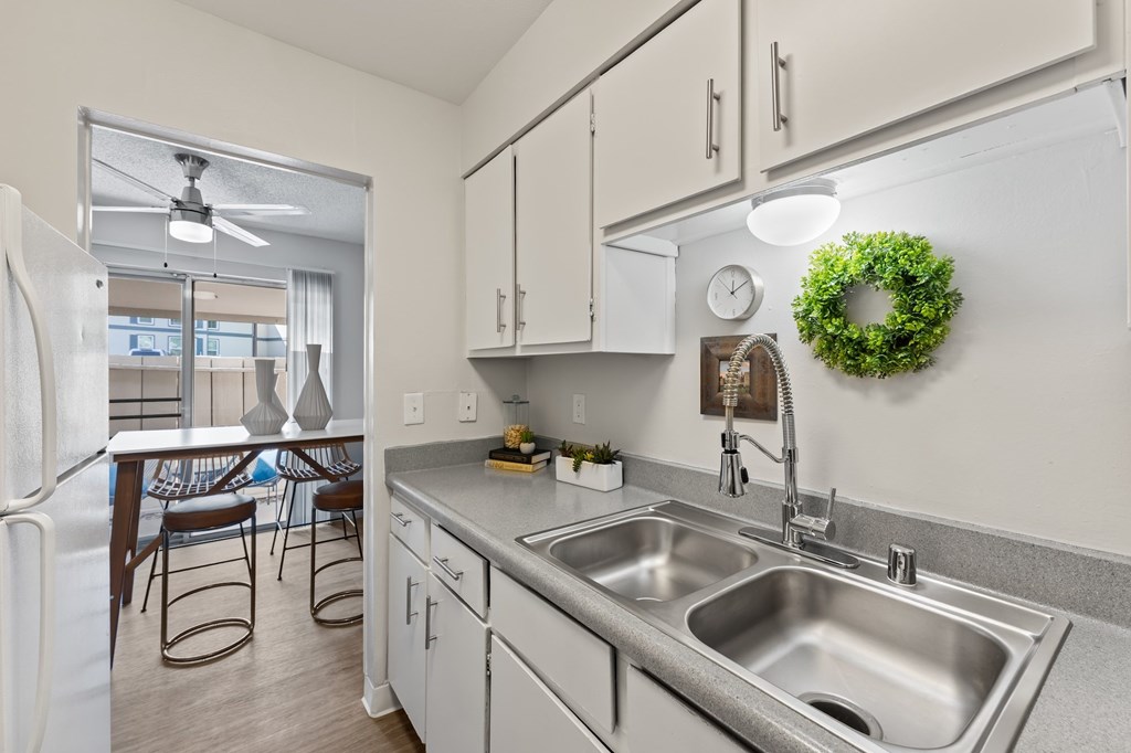 A kitchen with a wreath on the wall.