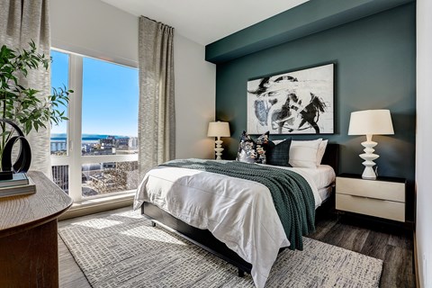 a bedroom with a bed and a large window