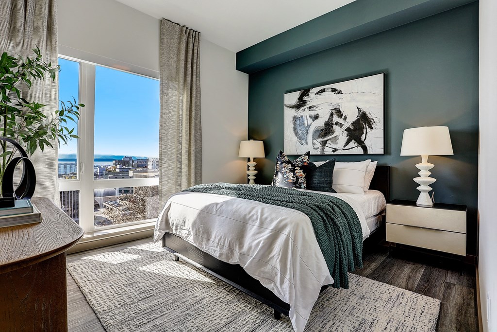 a bedroom with a bed and a large window
