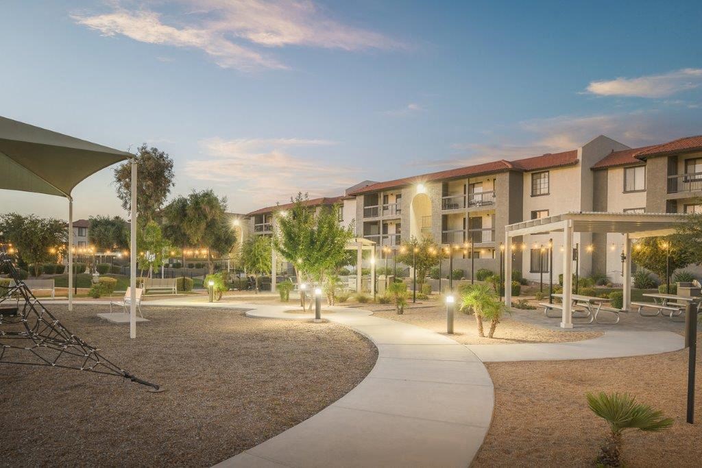 an exterior view of a courtyard at dusk