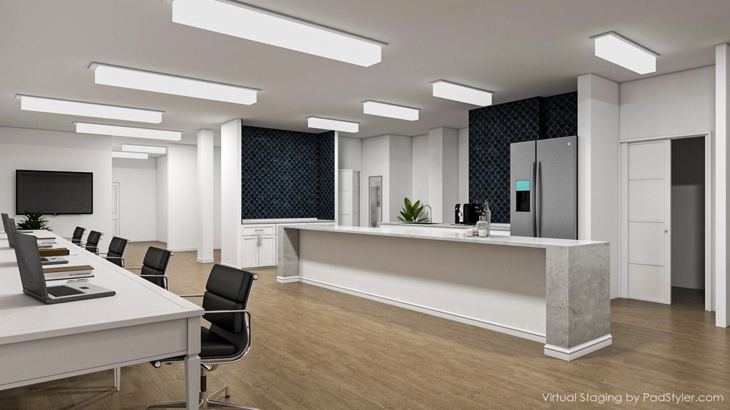 A modern office space with a long table and chairs.