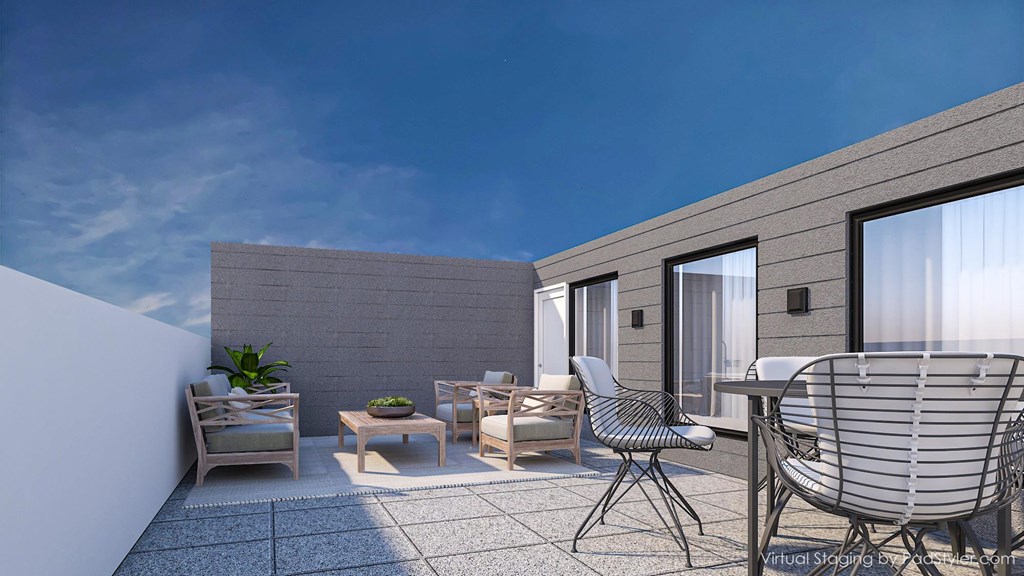 A patio with a table and chairs is shown in the image.