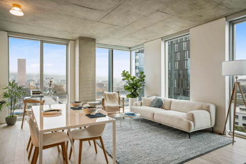 A modern living room with a dining table and chairs.