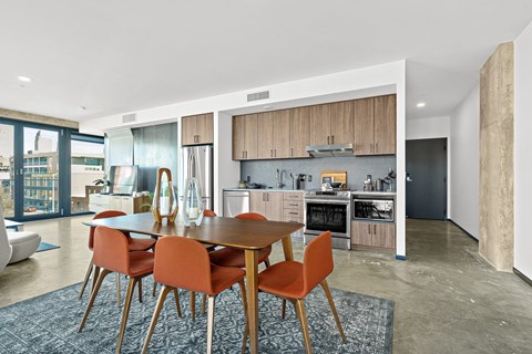 a kitchen and dining room with a table and chairs