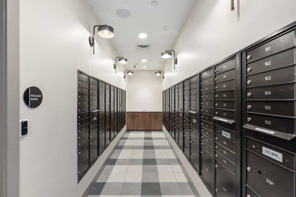 a long hallway with lockers in a room with a checkered floor