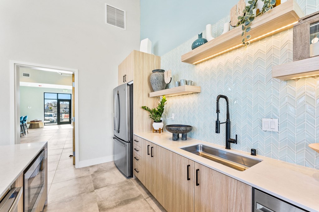 a kitchen with wooden cabinets and a sink and a refrigerator