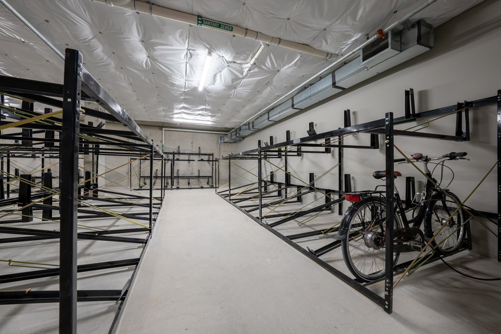 A long hallway with bicycles on the racks.