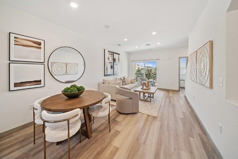 A modern dining room with a round table and chairs.