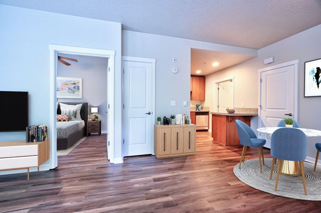 an open living room and kitchen with a table and chairs